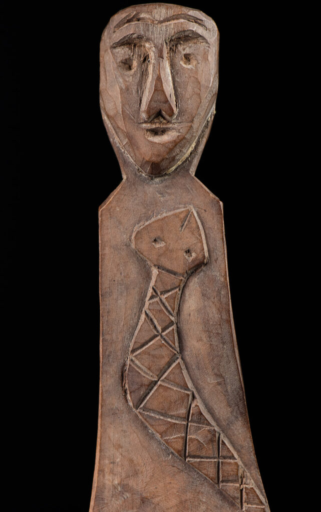 Old wooden spoon from the Paiwan tribe, carved with a one hundred pace snake at the back and one human head and sacred snake at the front.