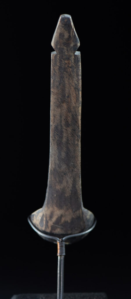 Old wooden spoon from the Paiwan tribe, carved with a standing figure and a deer at its feet.