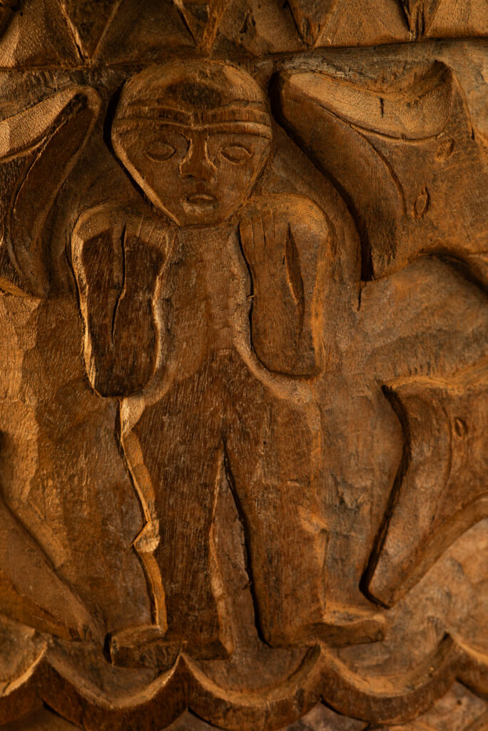 Ancient granary chest from the Paiwan tribe, used to store millet grains. Richly carved with sacred snakes, human heads, circular motifs, and anthropomorphic figures.