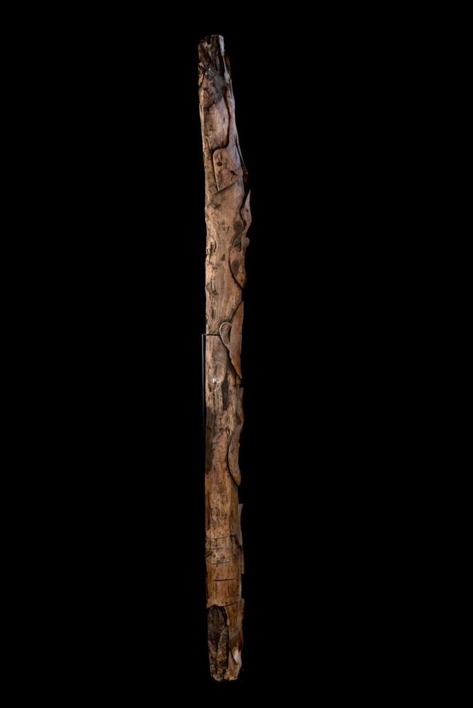 Ancient Paiwan tribe pillar , part of the inside partition, carved with human faces and sacred snakes.