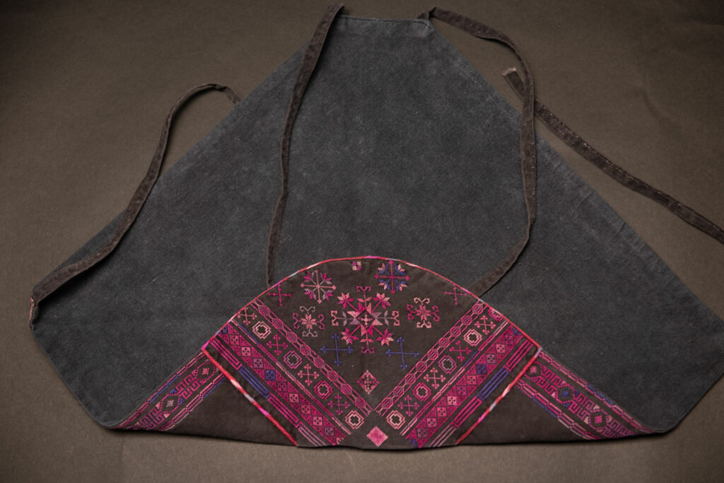 Female chest covering Puyuma tribe . The chest covering is crafted in a diamond shape and features intricate embroidery.