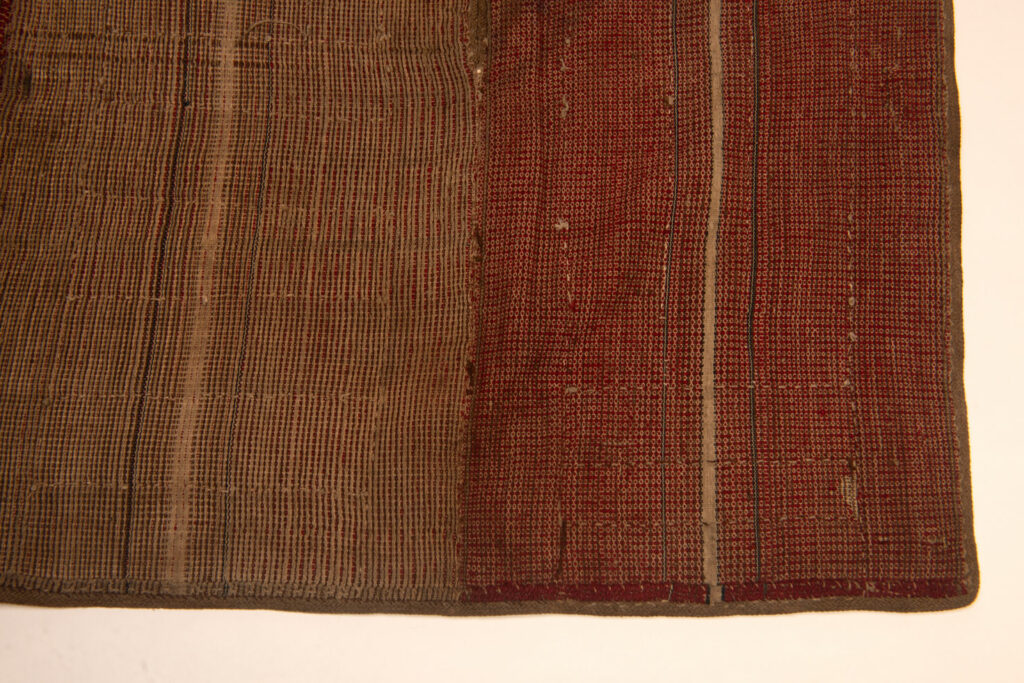 This beaded skirt from Attayal tribe is a piece of 89 cm long and 42 wide linen woven and embroidered with white shell beads. The white beads are made from giant clams. The Patterns are horizontal and vertical stripes . The upper part ( 14 cm ) is not beaded,