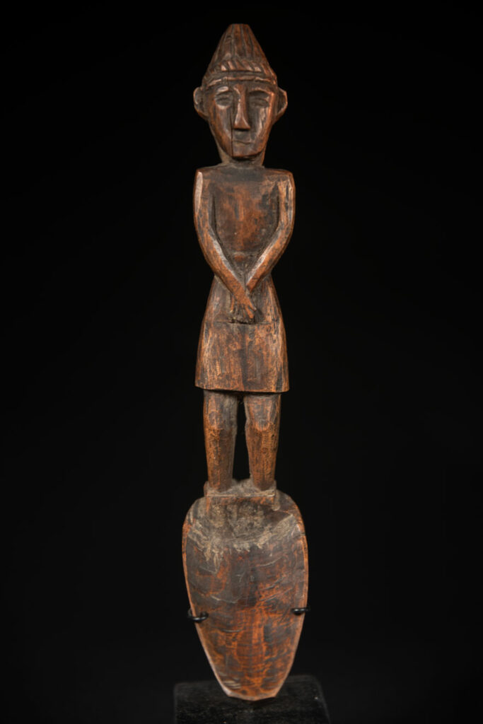 Large spoon from the Paiwan tribe, carved with a Paiwan man in traditional attire. Very finely carved.