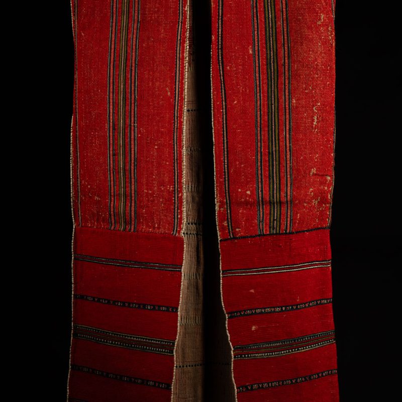19 century Long men's jacket from the Atayal tribe, entirely woven in red with black and white stripes, and adorned with bone beads along the edges.
