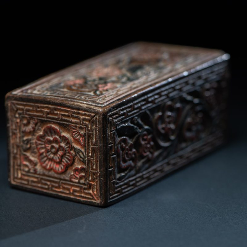 Ancient Pingpu Tribes wooden box with a sliding lid carved with the typical Pingpu tribe flower pattern and paint with red and black pigments.