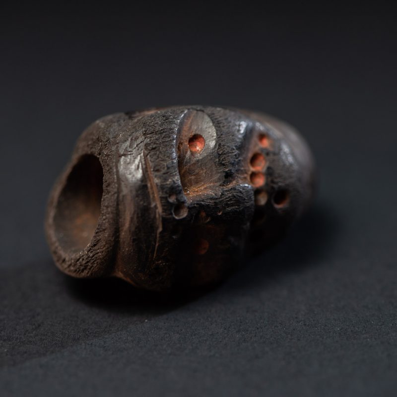 Paiwan tribe pipe bowl carved with a human face.