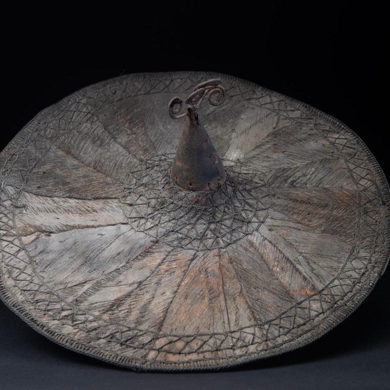 This ancient hat from the Yami- Tao tribes, orchid Island, Taiwan was worn by the female for work in the fields It is named “Varogot”. It is done with coconut palm bark, rotaing, aluminium and iron for the top decoration..