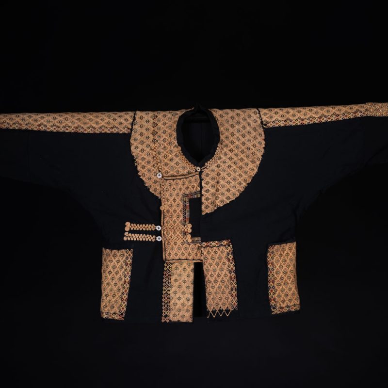 Male sleeve jacket from Rukai tribe , Black cotton and embroidered cloth pieces . This long sleeved short jacket is worn by noble men.