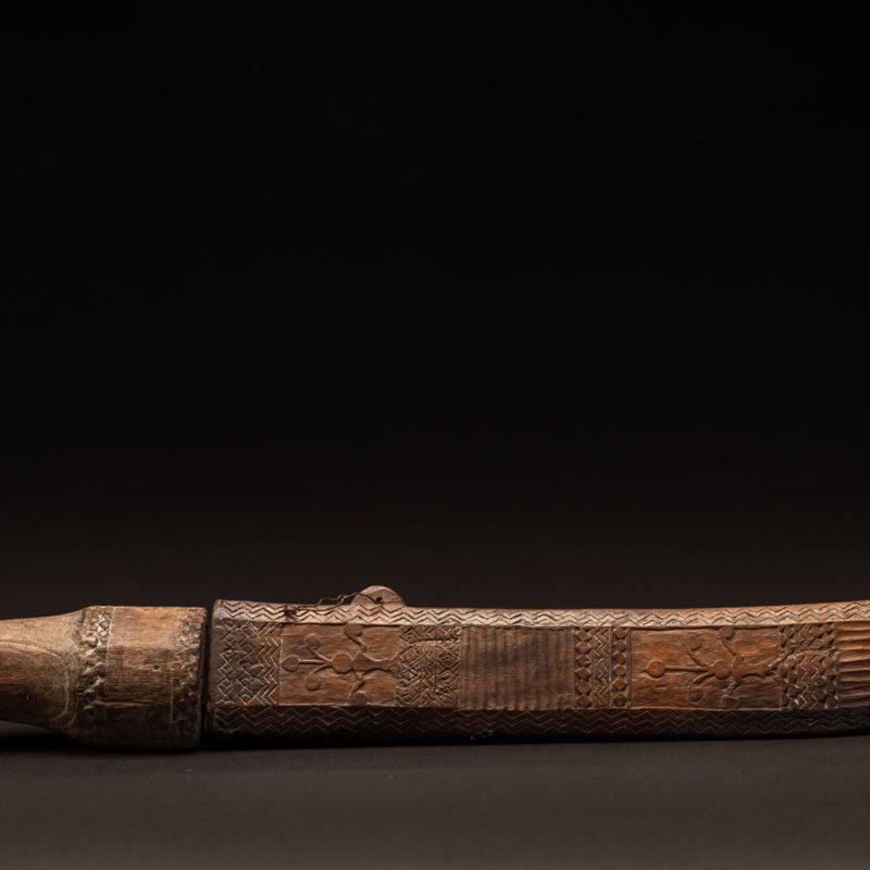 ‘Ipagan’ Knife and its sheath from the Yami (Tao) tribe. A fine example of the “Ipagan”, a short sword used to exorcise evil spirits but also to harvest. This sword, shorter than the Pararowai model, is notable for having both its handle and sheath carved with wave patterns, triangles, and the figure of the god Magamaog.