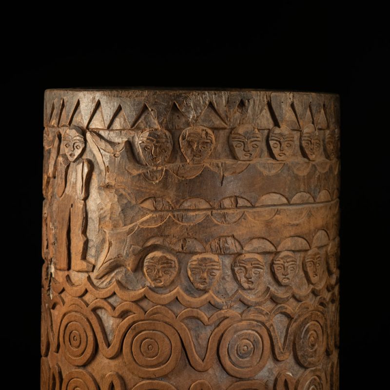 Ancient granary chest from the Paiwan tribe, used to store millet grains. Richly carved with sacred snakes, human heads, circular motifs, and anthropomorphic figures.