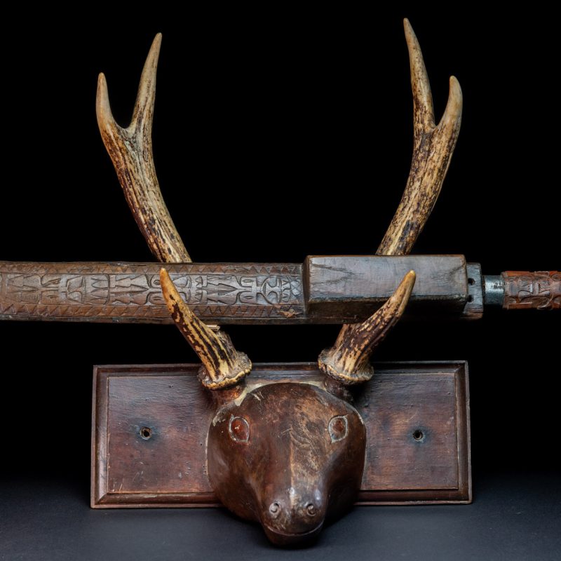 This great sword from the Paiwan tribe is decorated with embossed brass engraved with faces on the front and the side while the back is carved with three characters in the pure Paiwan style.