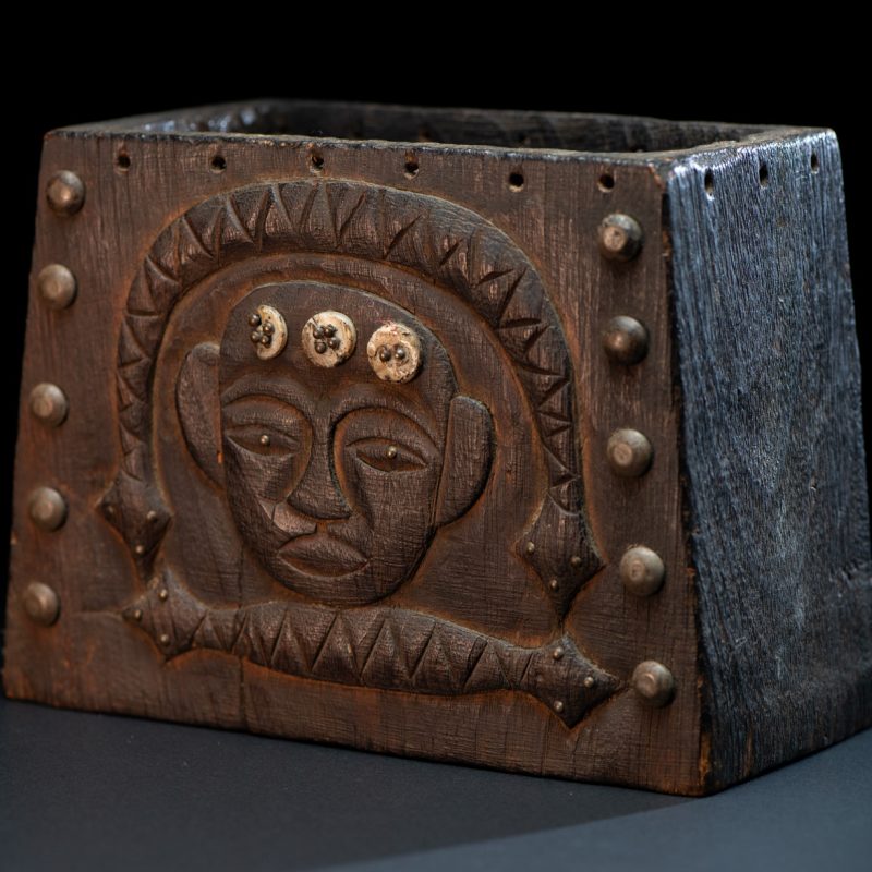 Paiwan tribe shaman box carved with a human head Wearing a two-headed snake as a headdress and other one on his neck. The edge of the shaman's box is studded with upholstery nails.