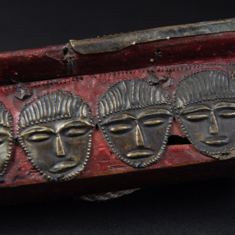 Paiwan tribe ancient sword painted in red, carved with standing figures and humain faces on the side.