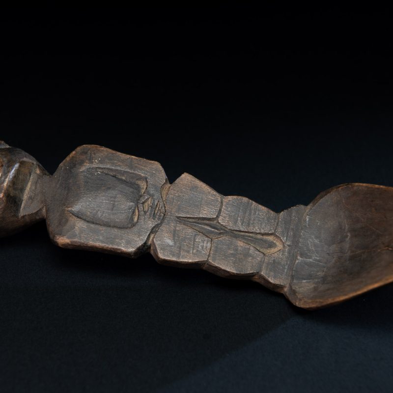 Old wooden spoon from the Paiwan tribe, carved with a standing figure .