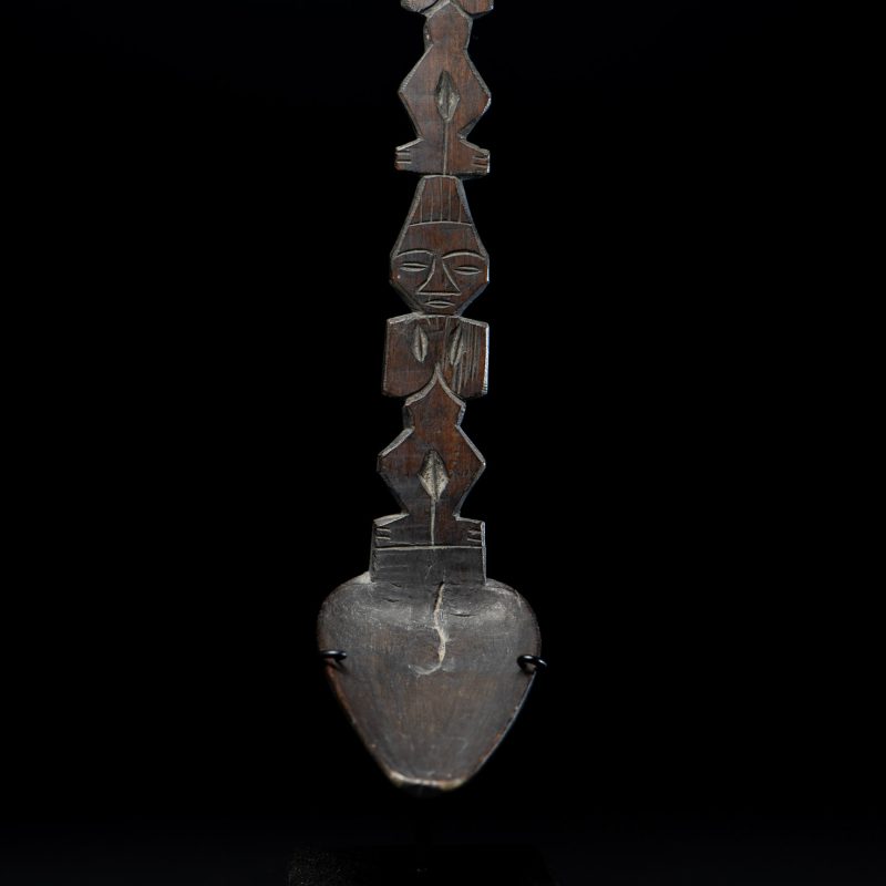 Ancient spoon from the Paiwan tribe, carved with two standing figures, one above the other.