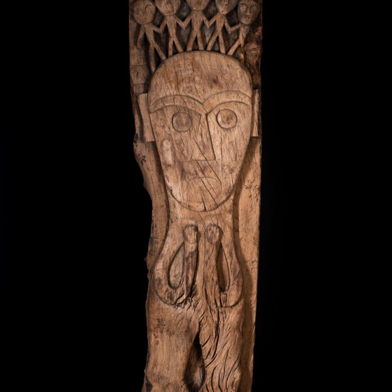 Rare and massive 19th-century Paiwan tribe shamanic ancestor panel, carved with a thick relief depicting a shaman with an oversized head crowned with multiple human faces — symbolizing his responsibility over the tribe’s spiritual and physical well-being.