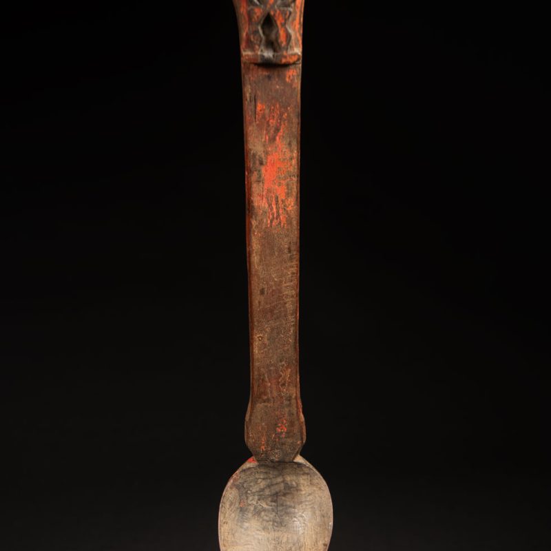 Beautiful 19th-century spoon, carved with a standing ancestor figure at the top and a magnificent double-headed serpent on the back. The spoon is stained red. Its size is 42 cm high.