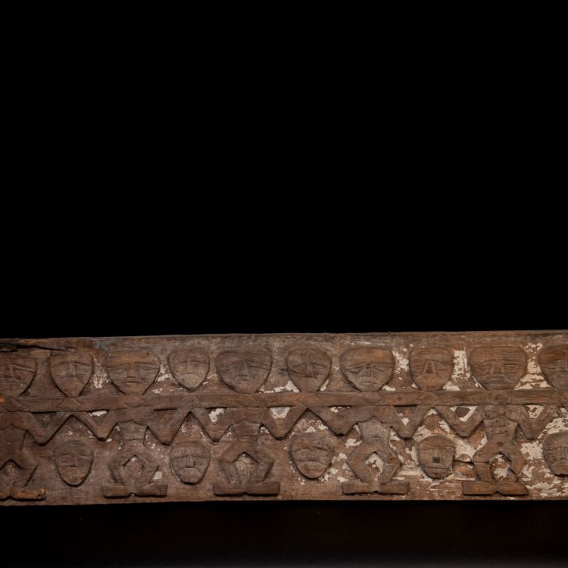 Paiwan tribe house eave carved with warriors drinking millet wine from a double cup — a symbol of unity — after a victory. Taiwan